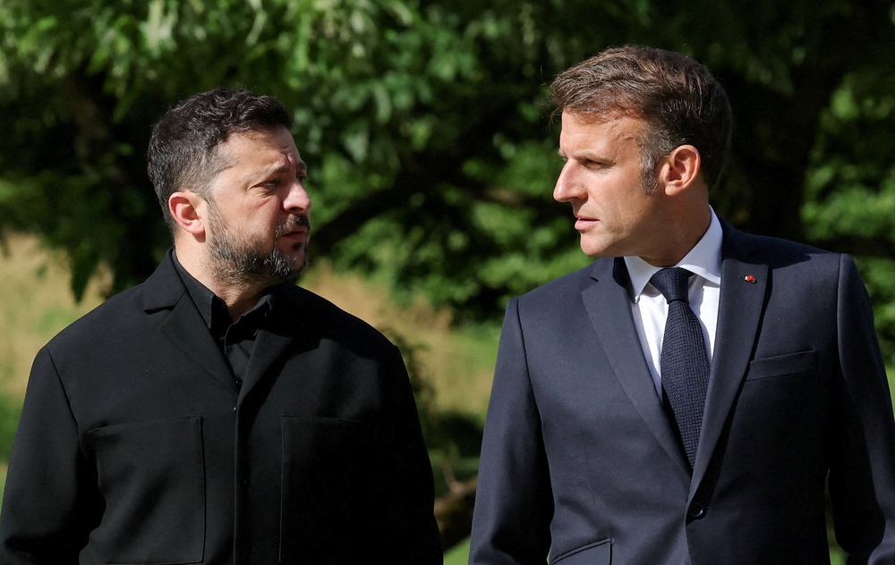 French president Emmanuel Macron and Ukraine's president Volodymyr Zelensky walk on the day of the G7 summit in Evian-les-Bains in France (Reuters)