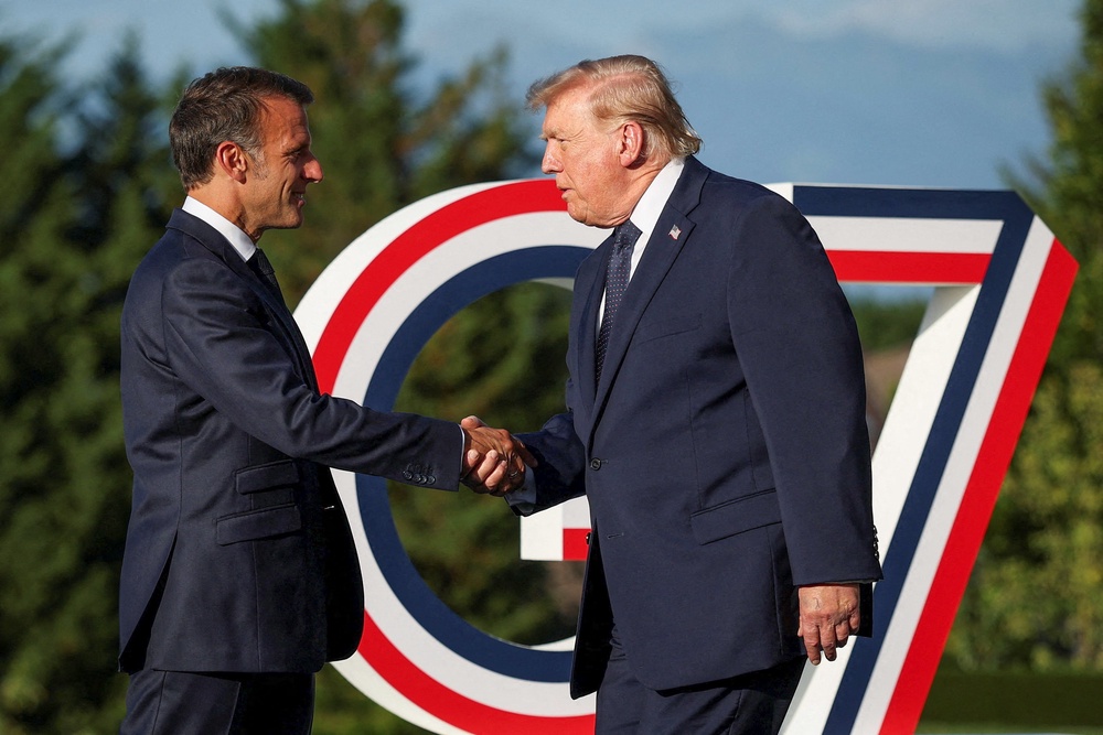 Emmanuel Macron (L) greets US President Donald Trump during the G7 summit, in Evian, central-eastern France, on June 15 (AFP/Getty)