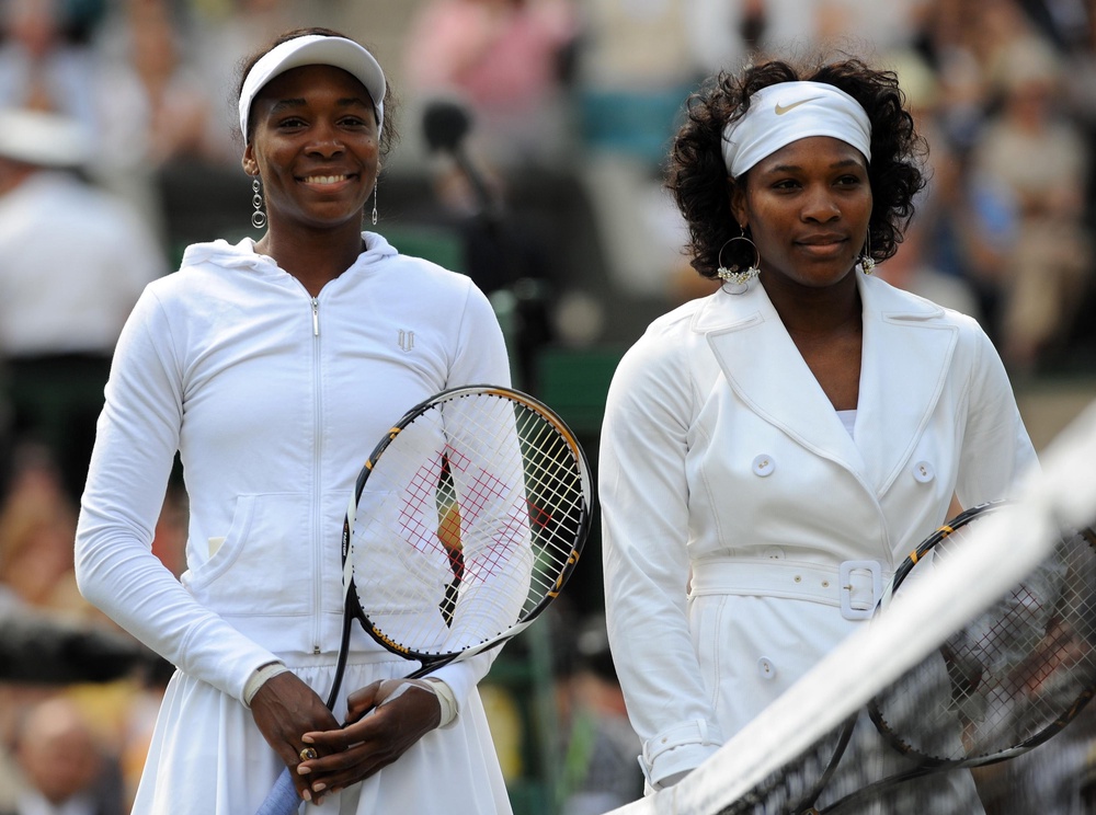 Serena and Venus during a match on Wimbledon’s Centre Court in 2008 (PA)