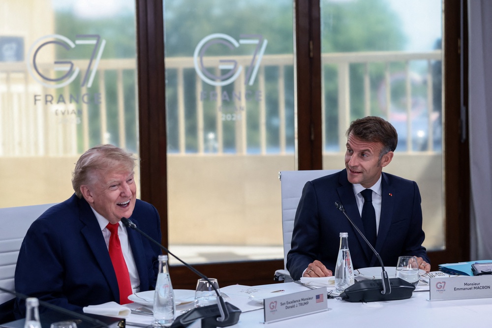Donald Trump and French President Emmanuel Macron attend a working lunch (Reuters)