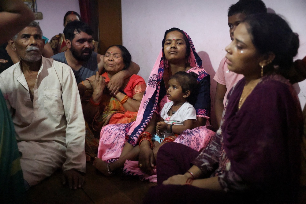 Family members of Shivanand Chaurasia, an Indian sailor killed in a US strike on oil tanker MT Settebello, mourn at their home in Deoria, Uttar Pradesh, on 13 June 2026 (Reuters)