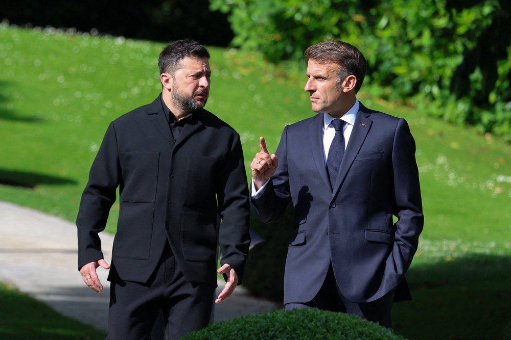 France's President Emmanuel Macron (R) greets Ukraine's President Volodymyr Zelensky ahead of the working session with G7 leaders and Ukraine during the G7 summit, in Evian, eastern France, on June 16, 2026. (AFP/Getty)