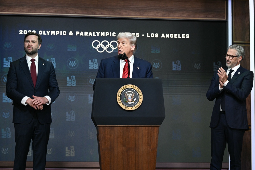 President Donald Trump, alongside Vice President JD Vance (L) and LA 2028 Chairman Casey Wasserman (R), speaks during an event to sign an executive order on creating a White House 2028 Olympics task force on August 5, 2025 (AFP/Getty)