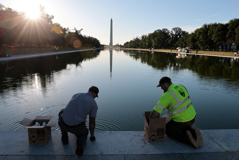 U.S. National Park Service workers dump bottles of hydrogen peroxide in the Lincoln Memorial Reflecting Pool as part of their effort to mitigate an algae bloom which followed the completion of recent renovations in Washington, D.C., U.S., June 16 (Reuters)