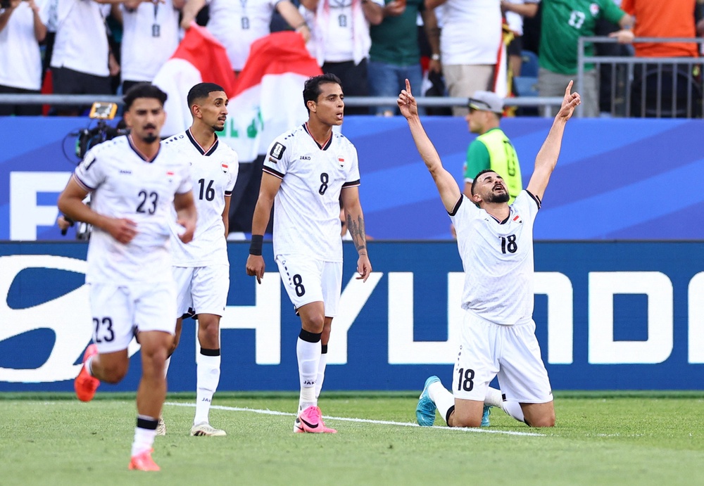 Iraq's Aymen Hussein celebrates scoring their first goal (Reuters)
