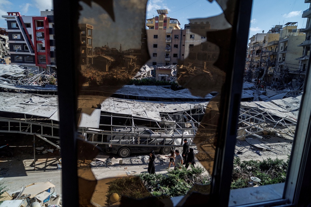 People walk past rubble at the site of an Israeli strike following a deal between the U.S. and Iran in Tyre, southern Lebanon, June 16 (Reuters)