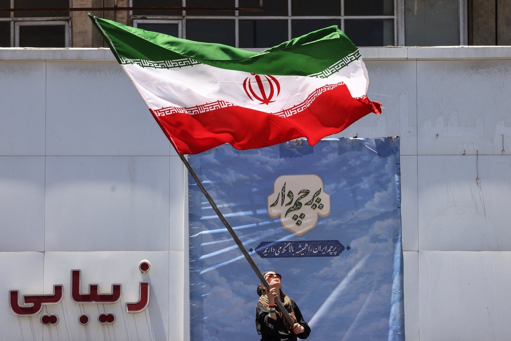 An Iranian woman waves a national flag at Valiasr Square in Tehran on June 15 (AFP/Getty)