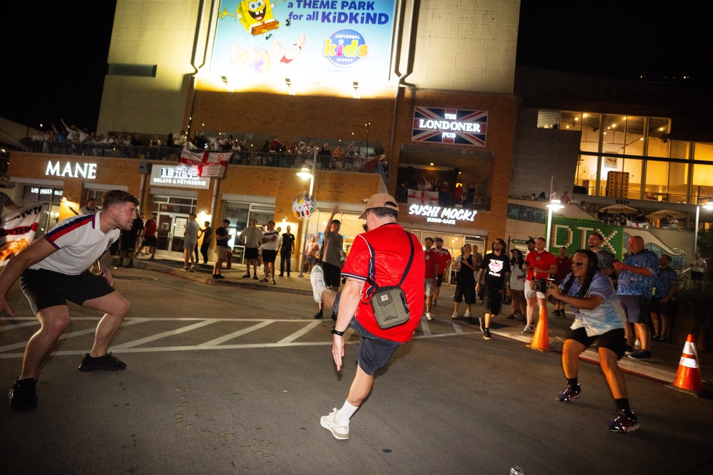 England fans kick footballs up to the balcony at the pub. (James Manning/PA)