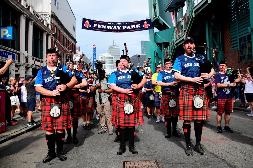 Scotland fans wearing kilts and playing the bagpipes during the march to Fenway Park (Reuters)