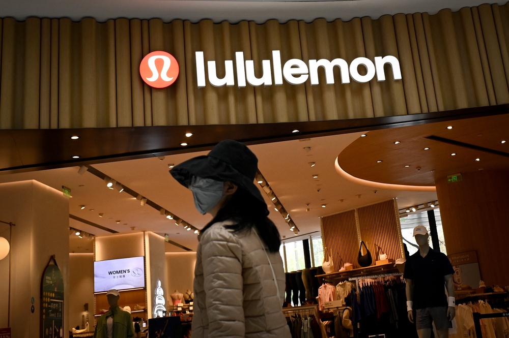 A shopper walks past a Lululemon store in Beijing on 15 April 2026 (AFP/Getty)