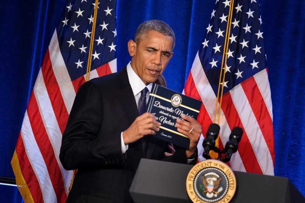 In his 2015 tweet, Trump heavily criticized the Iran nuclear deal signed during Obama's second term. Pictured here, Obama holds a copy of the Iran nuclear agreement presented to him by House Minority Leader Nancy Pelosi on January 28, 2016 (AFP via Getty Images)