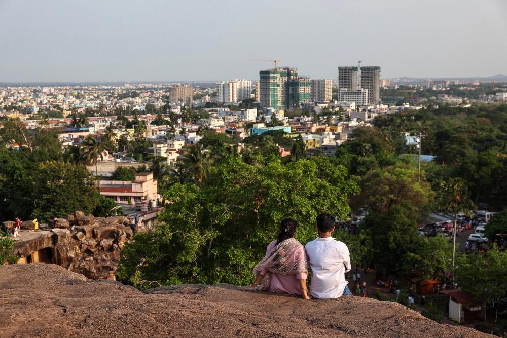 A couple looks at the city view while visiting the Udayagiri and Khandagiri Caves in Bhubaneswar on 3 May 2026 (AFP/Getty)