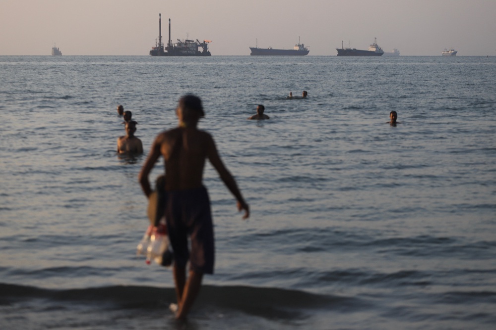 Under the terms of the deal, the US and Iran will agree to reopen the Strait of Hormuz, a vital trade route through which 20 percent of the world's oil passed before the war broke out. Pictured here, cargo vessels are seen anchored in the strait on June 8 (ISNA/AFP via Getty Images)