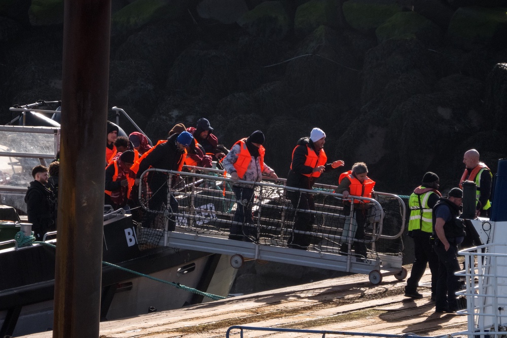 Migrants disembark from a Border Force vessel into Ramsgate port. AI age-checking technology works worse on faces aged by the stress of irregular journeys. (Getty)