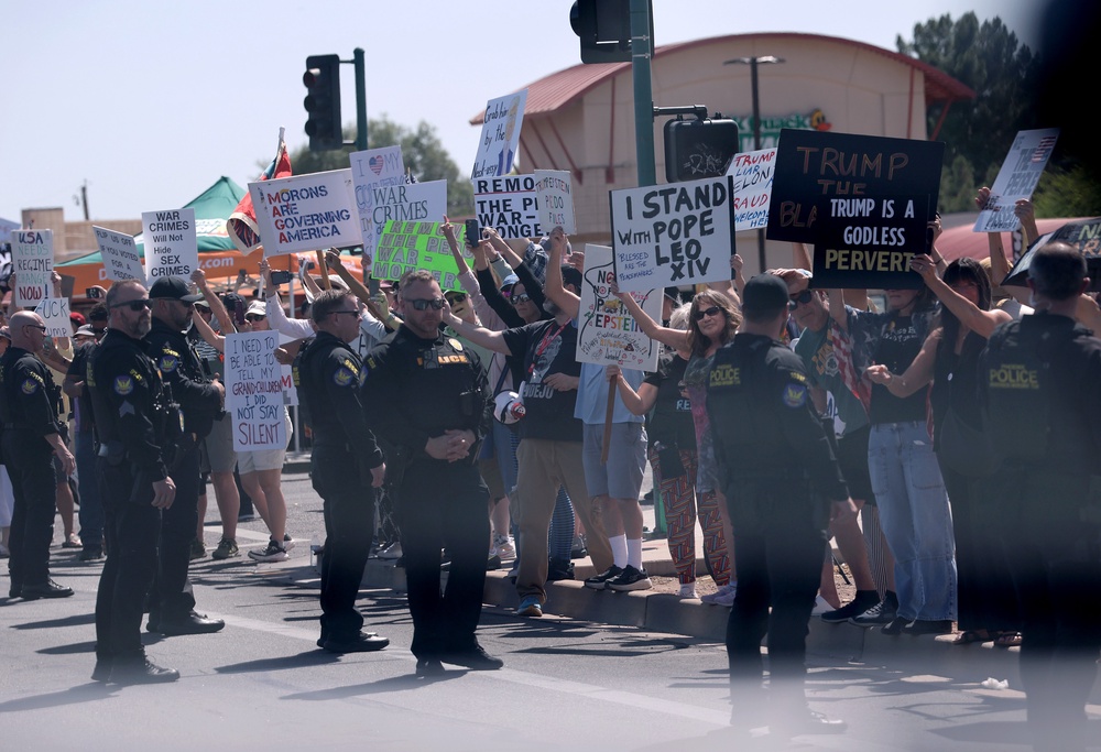 Protesters hold signs protesting the Trump administration in Phoenix, Arizona, in April. Arizona lawmakers are currently considering their own version of a 'civil terrorism' bill (Getty Images)
