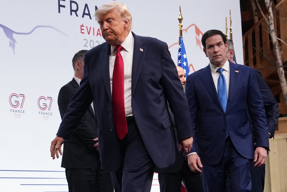 Donald Trump was flanked by some of the most senior members of his administration in France, including Marco Rubio and Scott Bessent (AP)