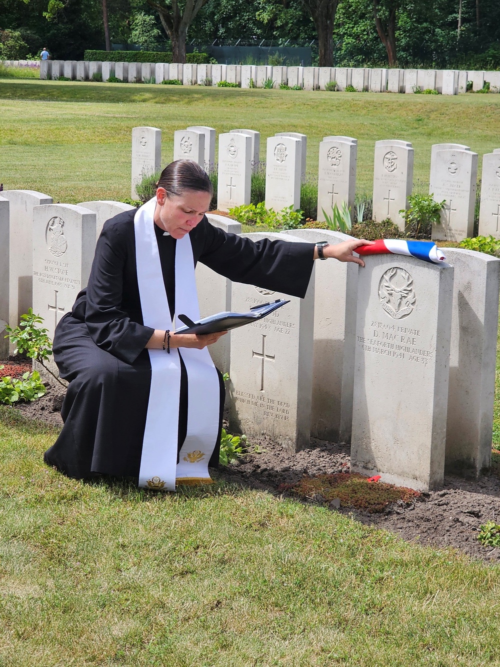 Padre Tiann Morgner blesses Donnie MacRae’s grave (Crown Copyright/PA)