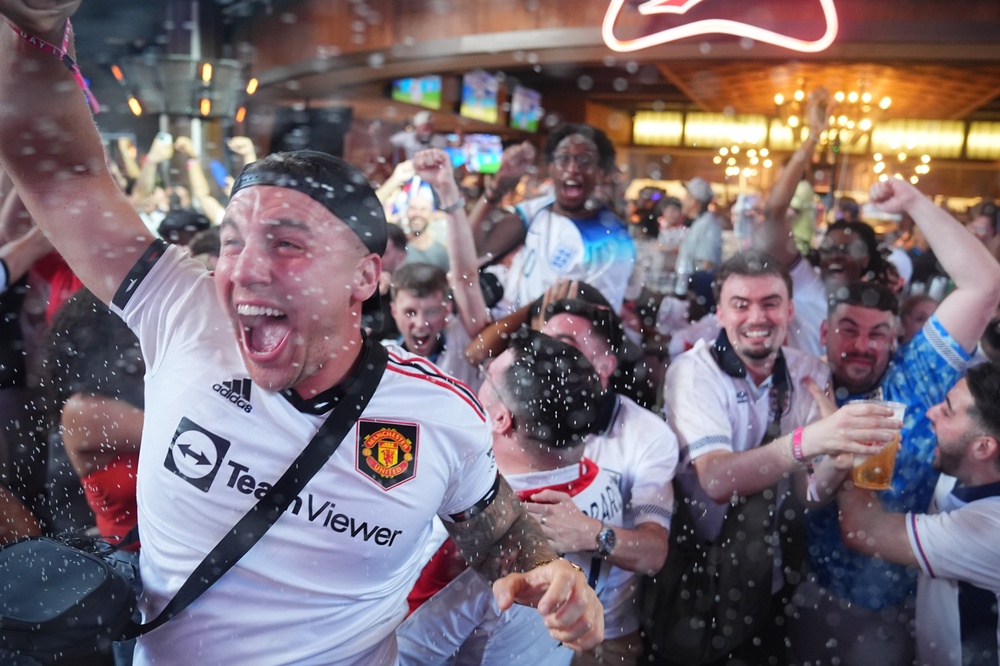 England supporters in the Texas Live! bar in Arlington celebrate after England score their fourth goal of the game (James Manning/PA) (PA Wire)