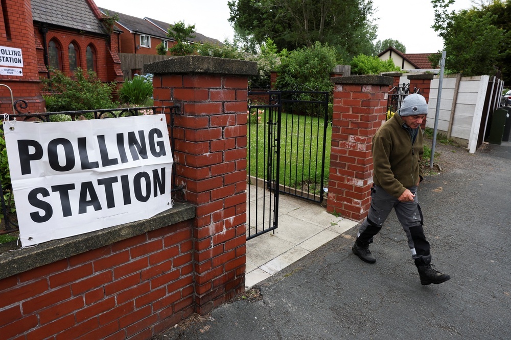 A person walks outside a polling station during the Makerfield by-election (Reuters)