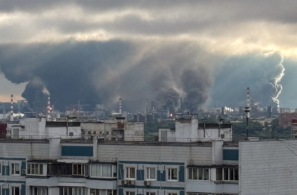 Thick plumes of smoke with flames rise from an oil refinery following what the authorities say is a Ukrainian drone strike in Moscow (Reuters)