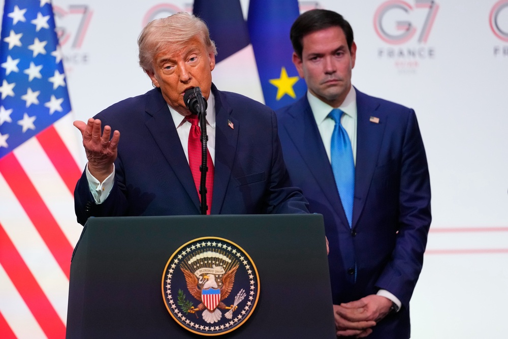 United States Secretary of State Marco Rubio stood behind Trump as the president discussed boasted of his Iran plan at the G7 (AP)