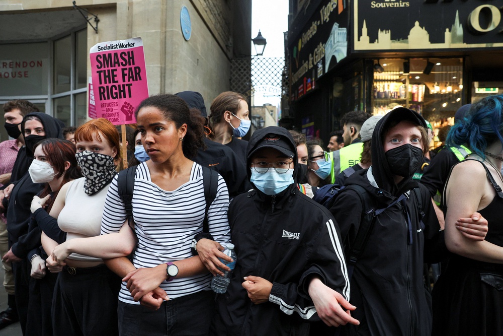 Protesters linking arms to block ticketholders from attending (Reuters)