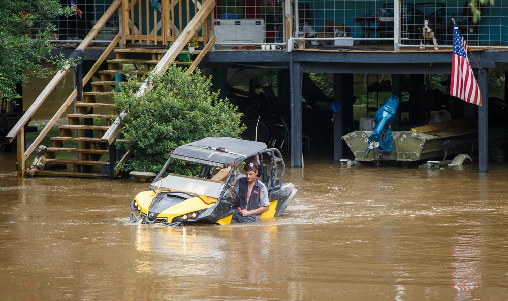 Dalton Saacks moves a mud buggy from the rising Tchefuncte River ahead of Tropical Storm Arthur near Folsom, La (AP)