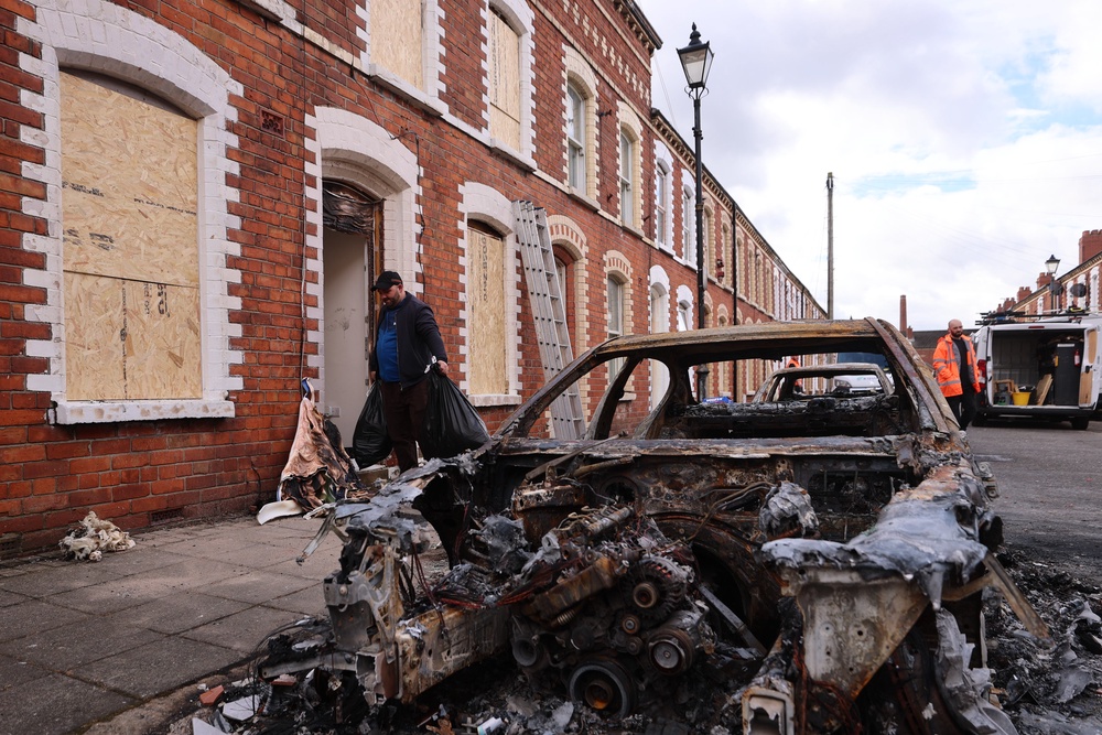 Burned-out cars and boarded-up houses on McMaster Street in east Belfast after the violence (Liam McBurney/PA) (PA Wire)