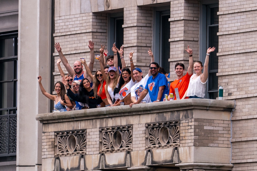 Revelers enjoy the parade from a balcony along the route (Getty Images)