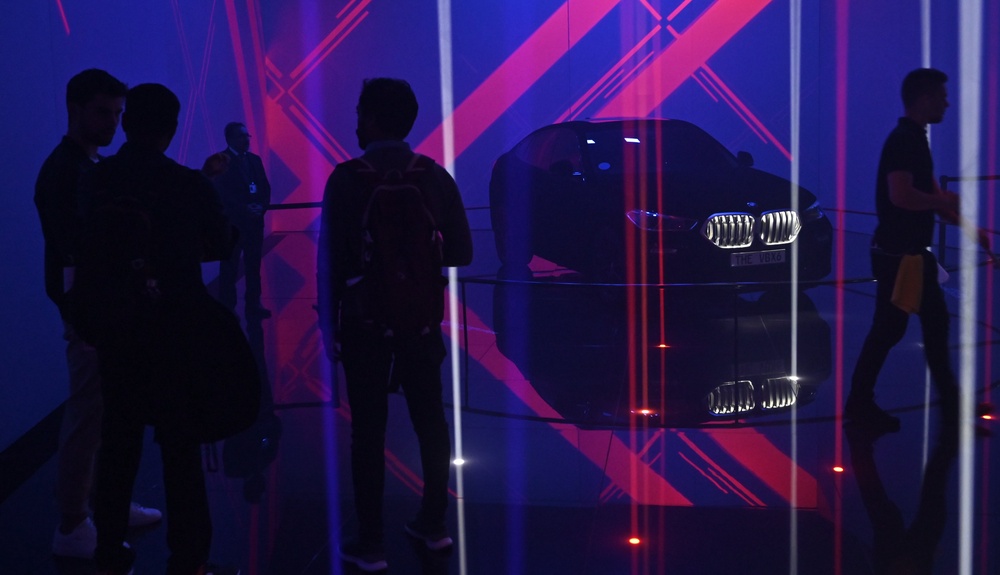 People stand near the BMW X6 Vantablack car during the International Auto Show in Frankfurt, Germany in September 2019. The car had a coating that also absorbed over 99 percent of visible light wavelengths (AFP via Getty Images)