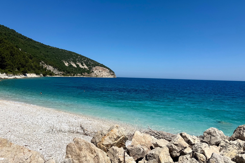The rocky shoreline of Sazan Island (Annabel Grossman/The Independent)