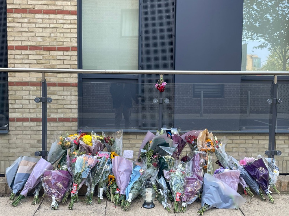 Floral tributes left outside a building in Mill Park in Cambridge where Mohammed Algasim was fatally stabbed (Independent Arabia)