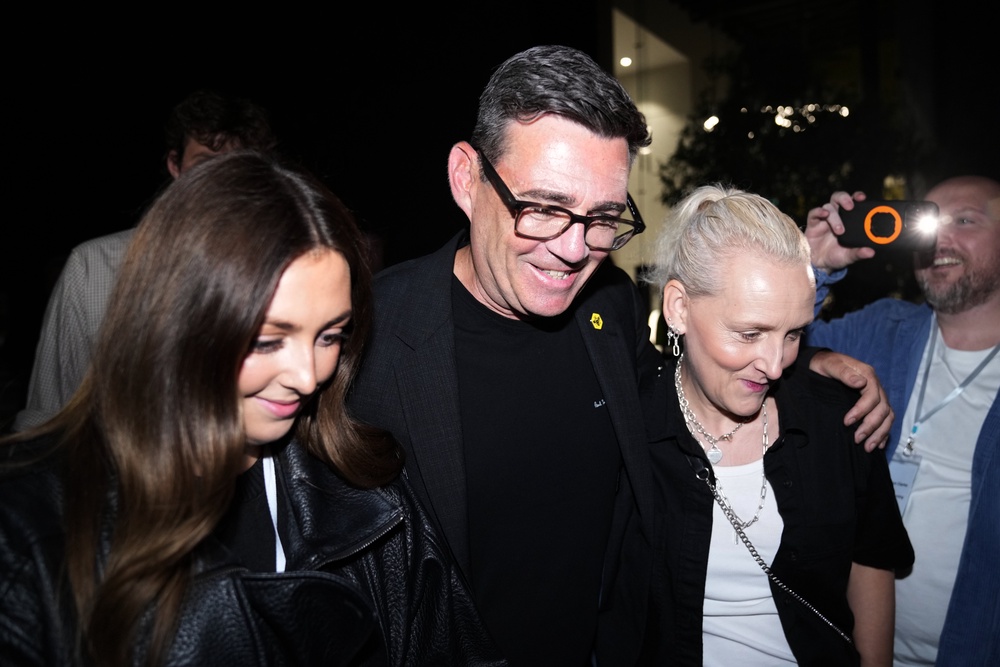 Andy Burnham pictured leaving the count with his wife and daughter (AP)