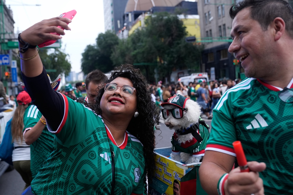 As thousands of fans streamed toward the stadium last week for the tournament opener, many stopped to snap photos, pet the dog and post videos online (Copyright 2026 The Associated Press. All rights reserved.)