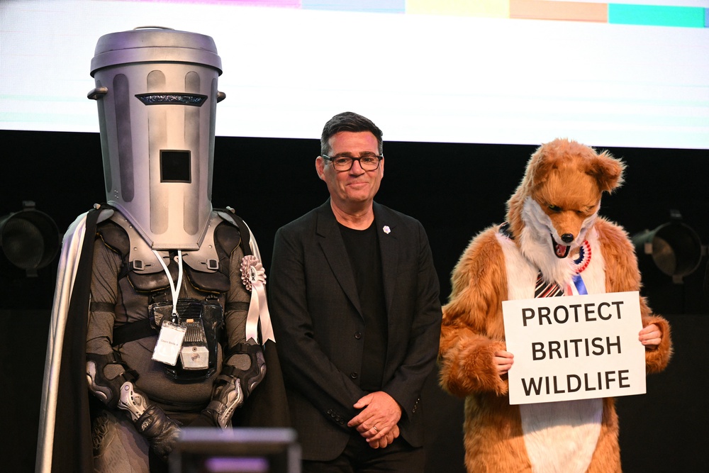Andy Burnham stands between fellow Makerfield candidates Count Binface (L) and Robert Pownall (R) (AFP/Getty)