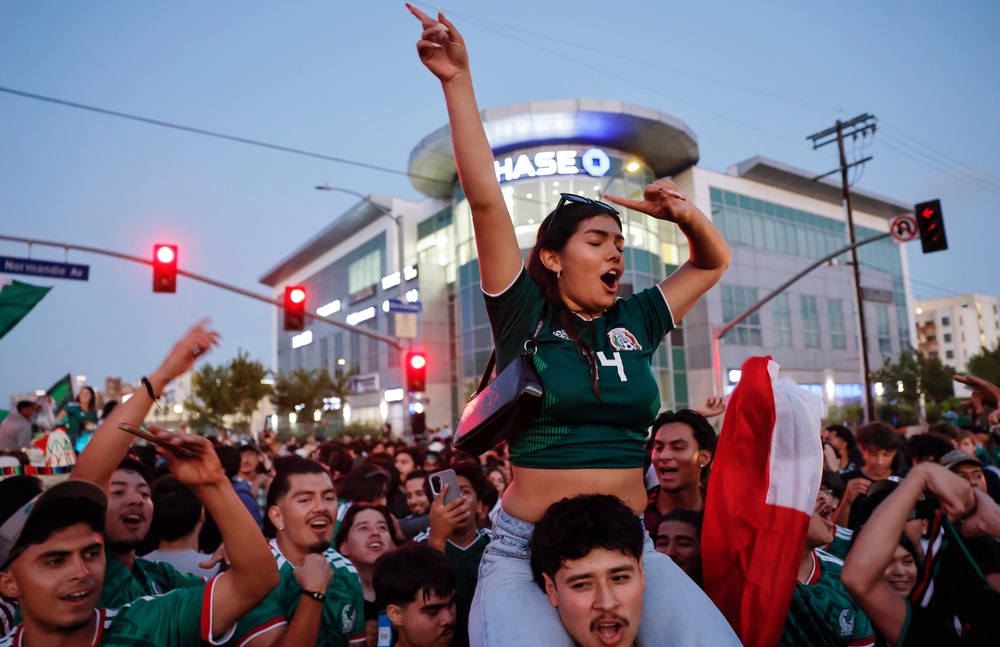 Mexico fans celebrate after Mexico won 1-0 over South Korea, after a watch party in Koreatown which is home to large Korean and Mexican communities (Getty)