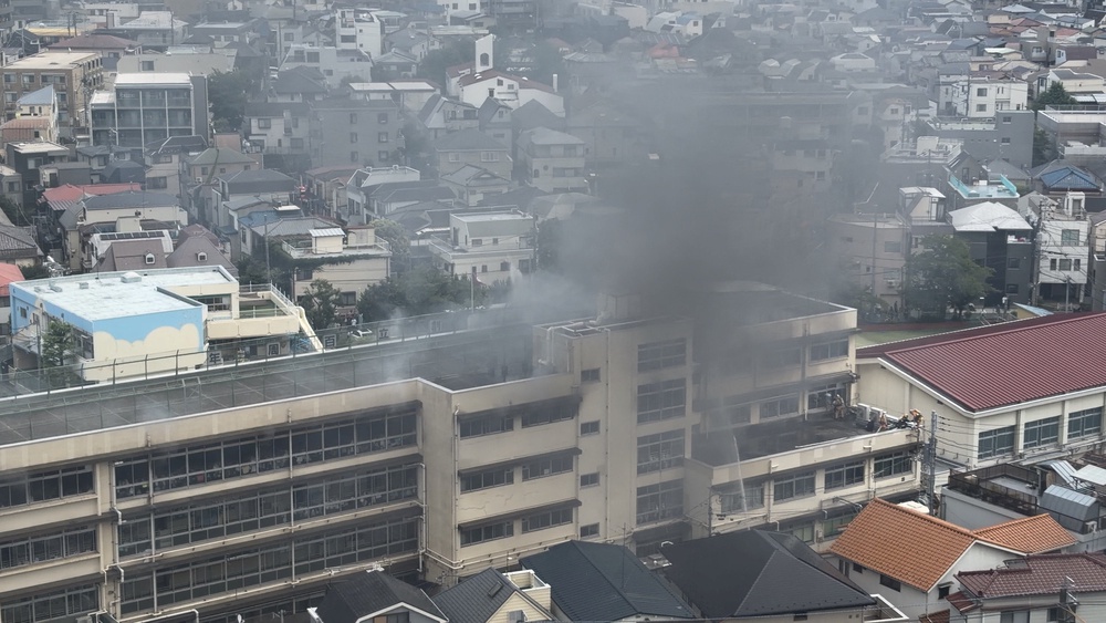 Smoke rises from a primary school after a fire in Kita, Tokyo (Reuters)