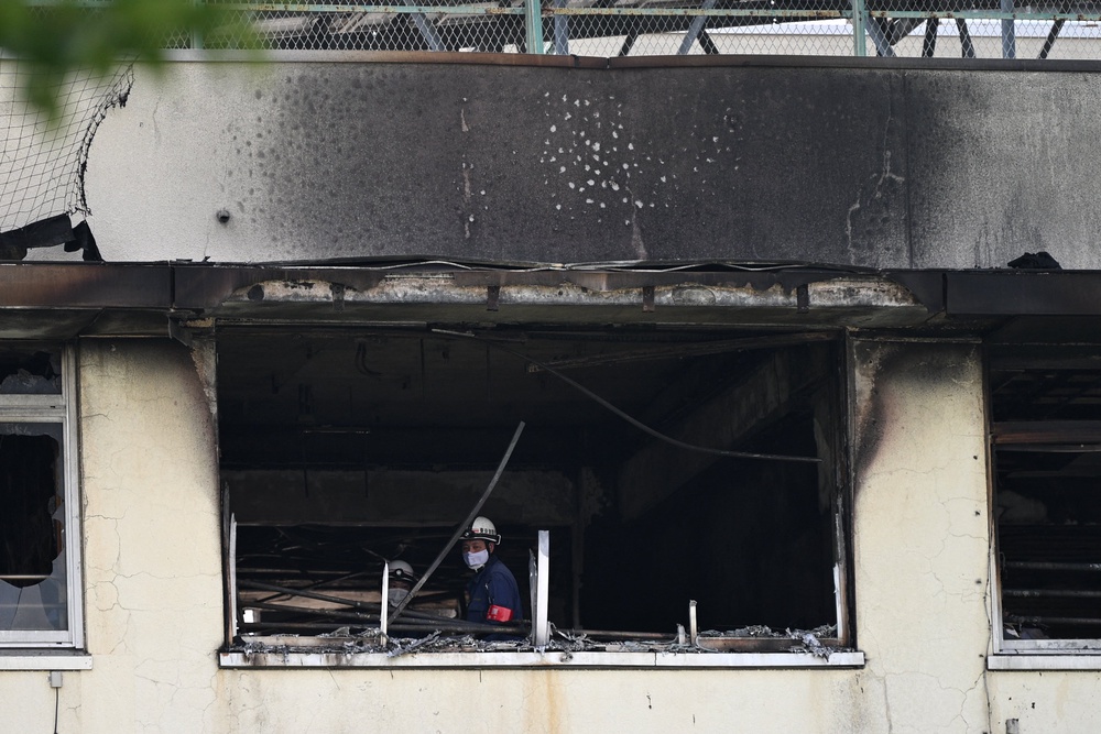 Firefighters work at the scene of a fire at an elementary school in Tokyo on 19 June 2026 (AFP/Getty)