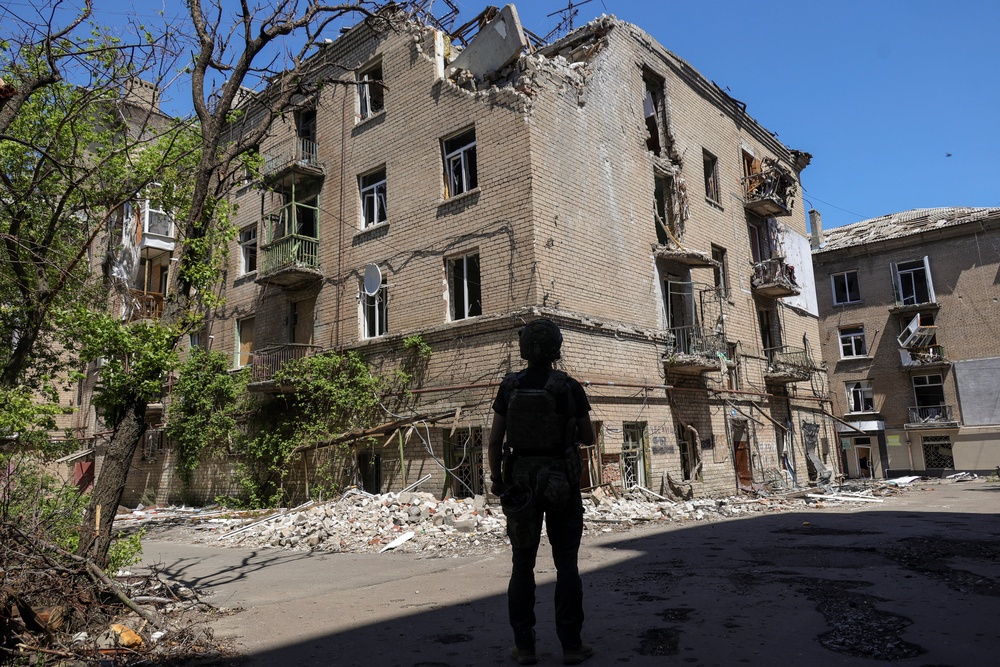 A Ukrainian serviceman looks at an apartment building damaged by Russian military strikes in the frontline city of Druzhkivka, amid Russia's attack on Ukraine, in Donetsk region, Ukraine June 19, 2026. (Reuters)