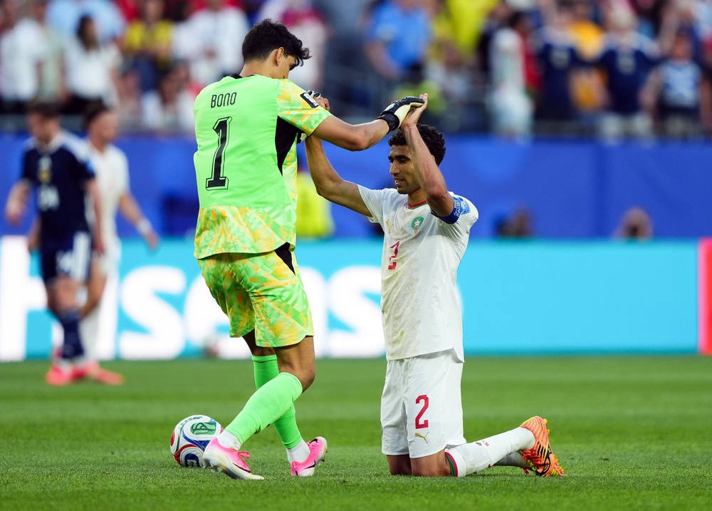 Morocco goalkeeper Yassine Bounou and Achraf Hakimi following the FIFA World Cup Group C match (PA)