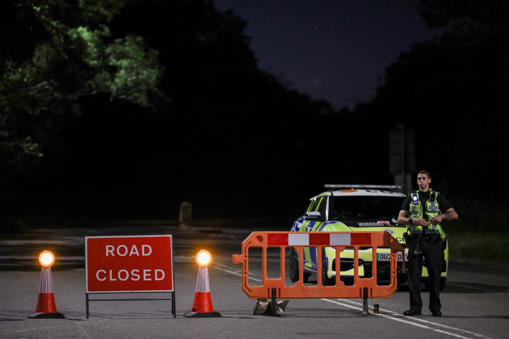 Police block a road that gives access into an area near the scene of a collision involving two trains near Bedford, Britain (Reuters)