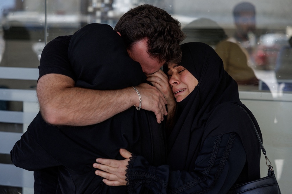 Relatives of the victims of an Israeli strike in Barish react outside Jabal Amel Hospital in Tyre, Lebanon, June 20, (Reuters)
