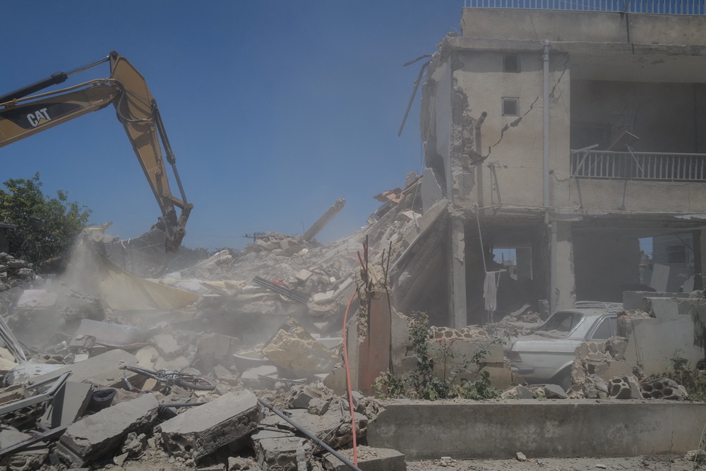 A machine works at the site of an Israeli air strike on a house as rescuers try to recover bodies from under the rubble, in Barish, in Tyre district, Lebanon June 20, 2026. (Reuters)