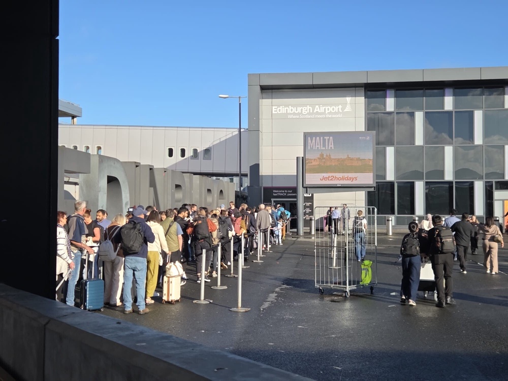 The queue extended outside the terminal building (PA) (PA Wire)