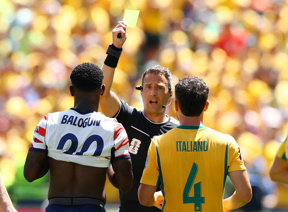 Referee Felix Zwayer shows a yellow card to Folarin Balogun (Reuters)