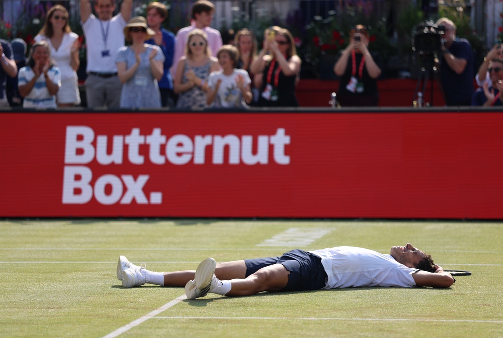 Cerundolo dropped to the ground in delight and exhaustion as he converted his fifth championship point (Getty)