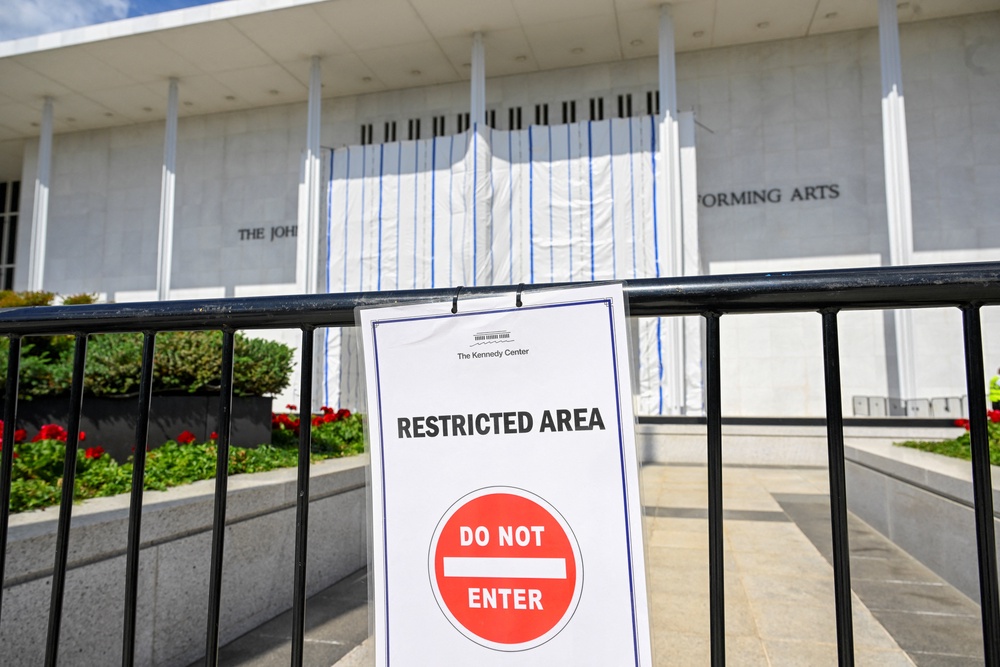 Pranksters used the tarp-covered Kennedy Center entrance to project images of Donald Trump and Jeffrey Epstein as similar projections popped up across Washington DC (Reuters)