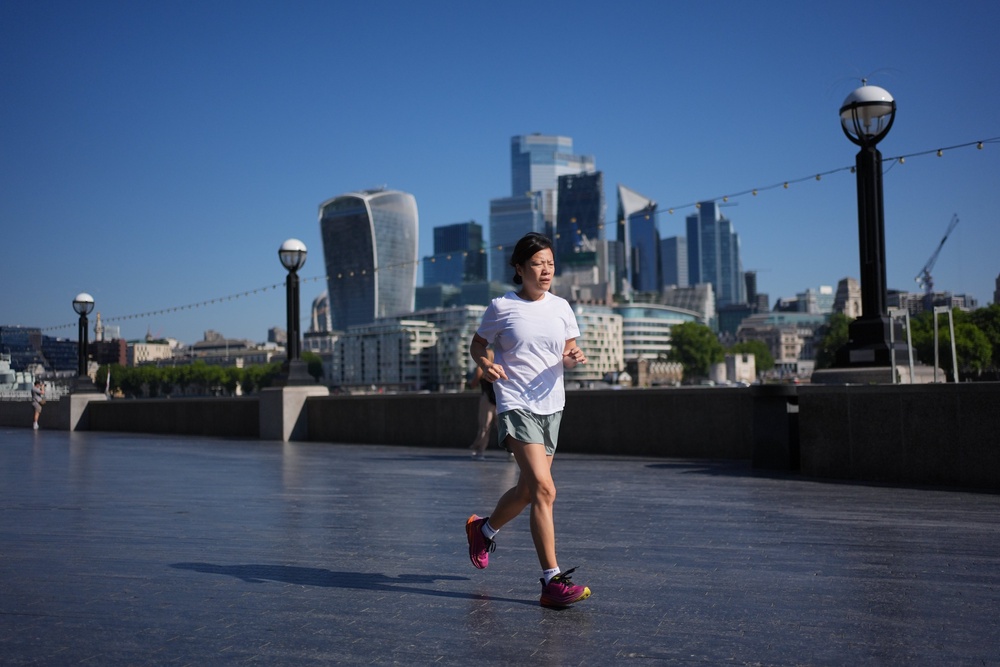 A person jogging on the Queen’s Walk in London as temperatures are forecast to soar (Yui Mok/PA)