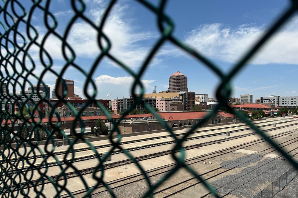 The tallest building in downtown Albuquerque, N.M., which houses the U.S. attorney's office, is seen beyond a chain link fence (Copyright 2026 The Associated Press. All rights reserved.)