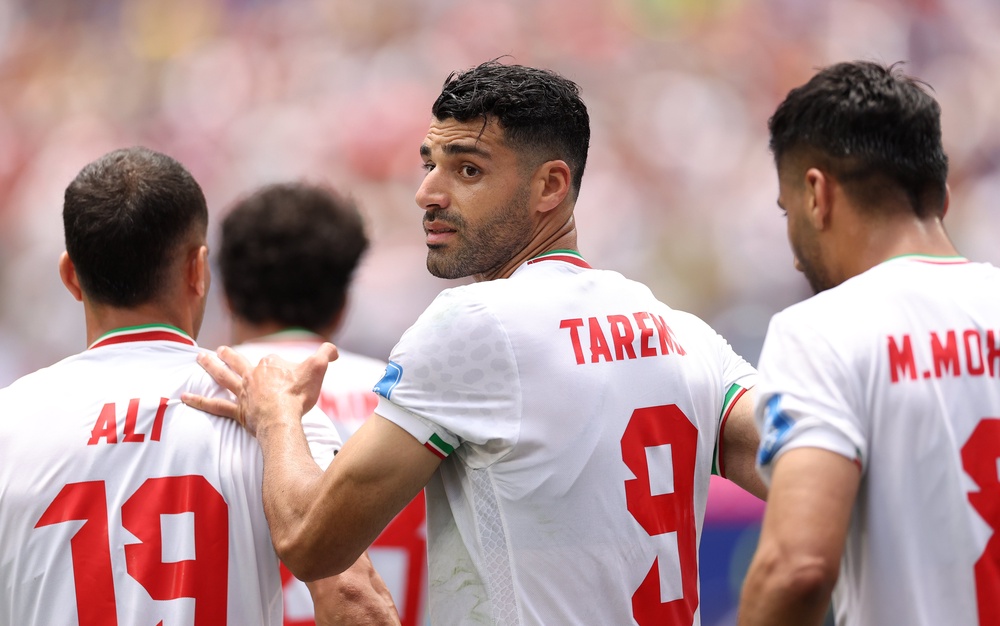 Mehdi Taremi #9 of IR Iran celebrates with team mates after scoring, only to have the goal disallowed, on Sunday (Getty)
